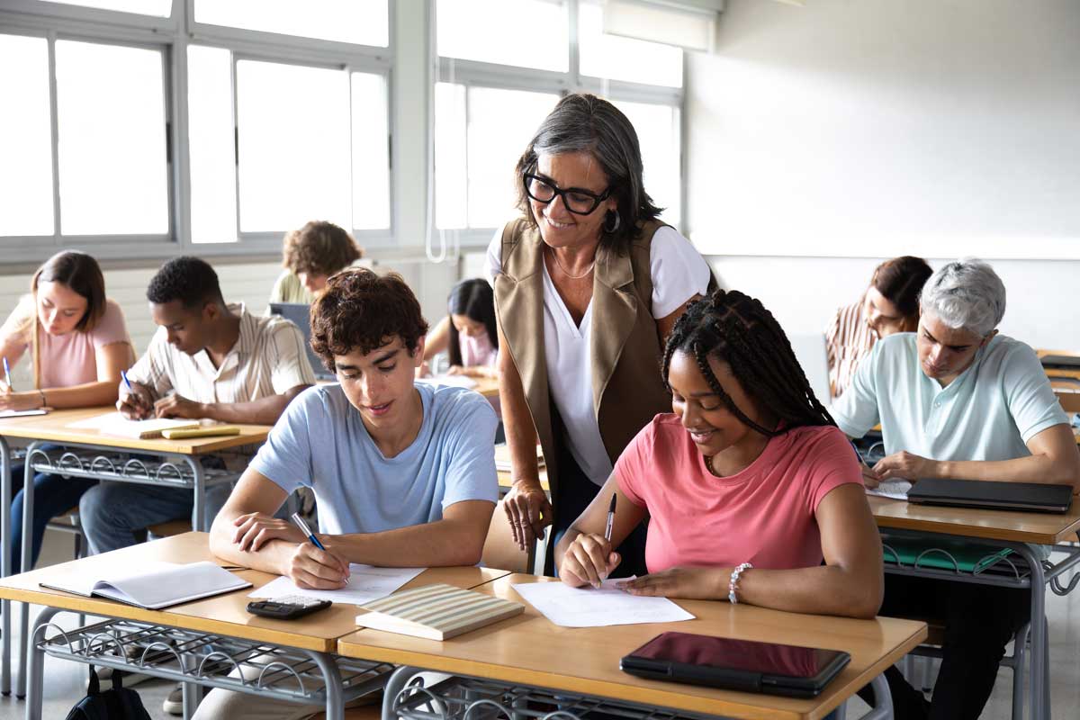 Teacher assisting high school students
